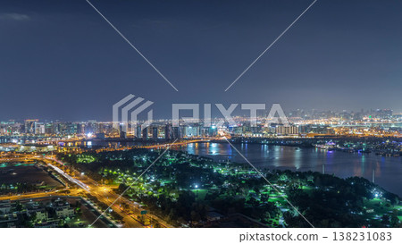 Nighttime rhythm of the city of Dubai near canal aerial timelapse Nighttime rhythm of the city of Dubai near canal aerial timelapse 138231083