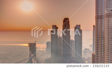 Amazing sunrise aerial view of Dubai downtown skyscrapers morning timelapse, Dubai, United Arab Emirates Amazing sunrise aerial view of Dubai downtown skyscrapers morning timelapse, Dubai, United Arab Emirates 138231133