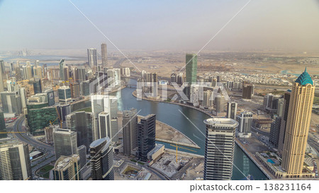 Panoramic aerial view of business bay towers in Dubai at evening timelapse. Panoramic aerial view of business bay towers in Dubai at evening timelapse. 138231164