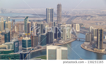 Panoramic aerial view of business bay towers in Dubai at evening timelapse. 138231165