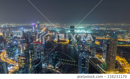 Panoramic aerial view of business bay towers in Dubai night timelapse. Panoramic aerial view of business bay towers in Dubai night timelapse. 138231170