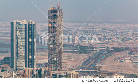 Panoramic aerial view of business bay towers in Dubai at evening timelapse. 138231171