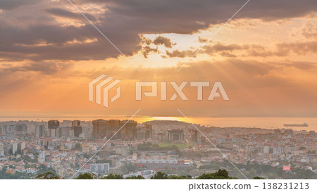 Panoramic sunrise view over Lisbon and Almada from a viewpoint in Monsanto morning timelapse. 138231213
