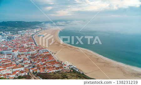 Nazare panorama with cabins of Funicular timelapse. Fog coming from ocean at evening during sunset. 138231219