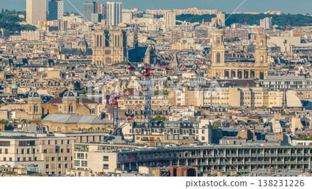 Aerial panorama above many houses rooftops in a Paris timelapse 138231226