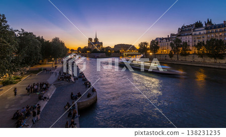 Rear view of Notre Dame De Paris cathedral day to night timelapse after sunset. 138231235