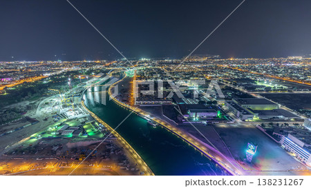 Dubai water canal with footbridge aerial night timelapse from Downtown skyscrapers rooftop Dubai water canal with footbridge aerial night timelapse from Downtown skyscrapers rooftop 138231267