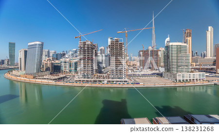 Skyscrapers near canal in Dubai with blue sky aerial timelapse Skyscrapers near canal in Dubai with blue sky aerial timelapse 138231268