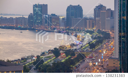 Dubai creek landscape day to night timelapse with boats and ship near waterfront Dubai creek landscape day to night timelapse with boats and ship near waterfront 138231383