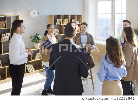 Team in circle with business coach during interactive leadership training 138231941