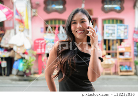 Thai Woman Tourist Calling on Smartphone in Phuket Old Town Thailand Thai Woman Tourist Calling on Smartphone in Phuket Old Town Thailand 138232036