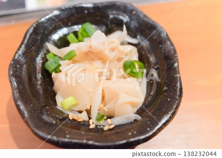 A small bowl dish featuring bamboo shoots as an appetizer. A small bowl dish featuring bamboo shoots as an appetizer. 138232044