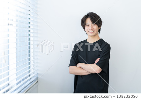 Young man relaxing by the window Young man relaxing by the window 138232056