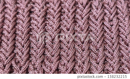 A relief openwork pattern knitted with colored yarn on a wooden background 138232215