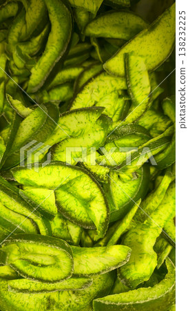 Dried mango slices close-up as a vibrant fruit texture background. Store display Dried mango slices close-up as a vibrant fruit texture background. Store display 138232225