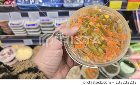Close-up of sauerkraut, pickled carrots and pickles on display in a grocery store Close-up of sauerkraut, pickled carrots and pickles on display in a grocery store 138232232