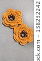 Crochet orange flowers with beads on a gray background. Design example. 138232242