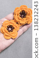 Crochet orange flowers with beads on a gray background. Design example. 138232243