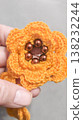 Crochet orange flowers with beads on a gray background. Design example. 138232244