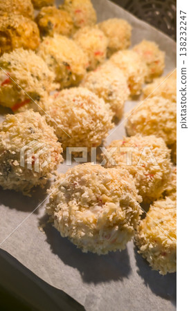 Sushi balls made of breaded rice and filling, baked in the oven, homemade food 138232247