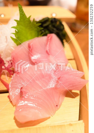 White fish sashimi served with shiso leaves and wakame seaweed. White fish sashimi served with shiso leaves and wakame seaweed. 138232259