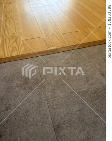 Close-up of a renovation project showcasing the use of different flooring materials (hardwood and cushion flooring) and finishing with transition strips. Close-up of a renovation project showcasing the use of different flooring materials (hardwood and cushion flooring) and finishing with transition strips. 138233598