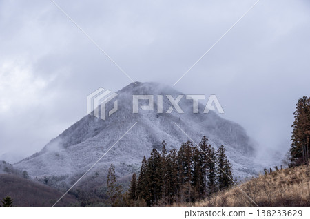A winter landscape of barren mountaintops and cedar forests shrouded in mist. A winter landscape of barren mountaintops and cedar forests shrouded in mist. 138233629