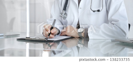 Doctor writing prescription or medical record, providing patient care and healthcare services in clinic. Medicine and health care 138233735