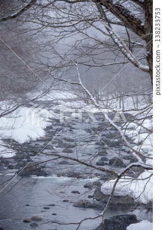 The Inagawa River flows through the snow-covered village of Hinoemata, with snow-capped rocks and a wintery mountain stream landscape. The Inagawa River flows through the snow-covered village of Hinoemata, with snow-capped rocks and a wintery mountain stream landscape. 138233753