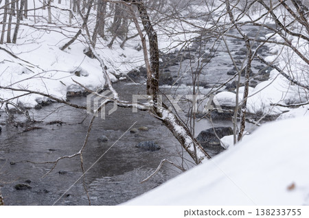The Inagawa River flows through the snow-covered village of Hinoemata, with snow-capped rocks and a wintery mountain stream landscape. The Inagawa River flows through the snow-covered village of Hinoemata, with snow-capped rocks and a wintery mountain stream landscape. 138233755