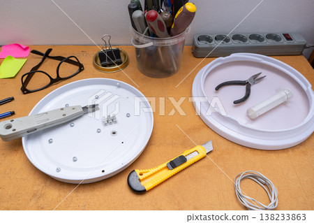 LED lamp repair. Disassembled ceiling chandelier. Utility knife, pliers and screwdrivers LED lamp repair. Disassembled ceiling chandelier. Utility knife, pliers and screwdrivers 138233863