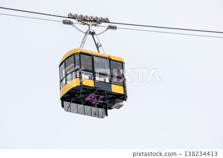 Aerial Cabin Suspended On Steel Line Against Overcast Sky 138234413