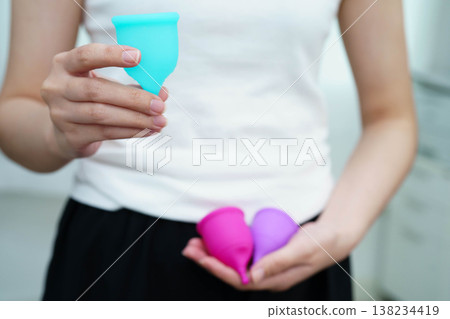 Asian woman holding menstrual cup for hygiene menstrual period cycle protection. Asian woman holding menstrual cup for hygiene menstrual period cycle protection. 138234419