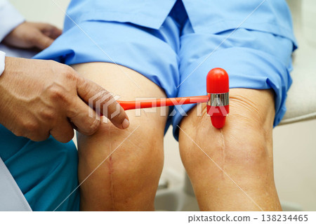 Asian doctor knock on knee reflex nerve for check and treatment senior patient in hospital. Asian doctor knock on knee reflex nerve for check and treatment senior patient in hospital. 138234465