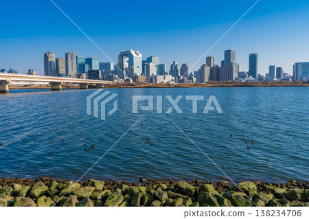 Osaka City: The Yodo River and the skyscrapers of Osaka Umeda on a clear winter day. Osaka City: The Yodo River and the skyscrapers of Osaka Umeda on a clear winter day. 138234706