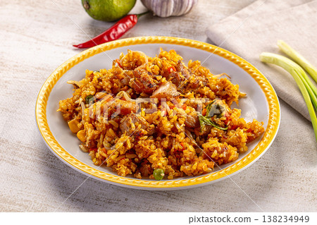 Savory fried rice with pork and vegetables on a plate with fresh lime, garlic, and chili Savory fried rice with pork and vegetables on a plate with fresh lime, garlic, and chili 138234949