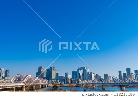 Osaka City: The Juso Bridge over the Yodo River and the skyscrapers of Osaka's Umeda district on a clear winter day. Osaka City: The Juso Bridge over the Yodo River and the skyscrapers of Osaka's Umeda district on a clear winter day. 138235199
