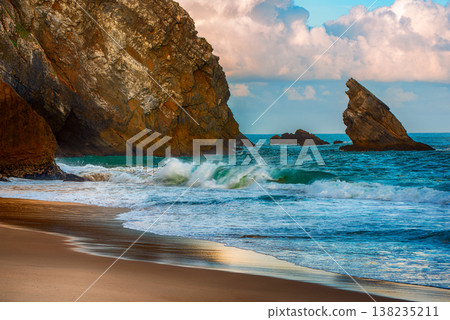 Praia da Adraga Coastal Archway in Sintra Portugal, beautiful beach with rocks in the sea ocean Praia da Adraga Coastal Archway in Sintra Portugal, beautiful beach with rocks in the sea ocean 138235211