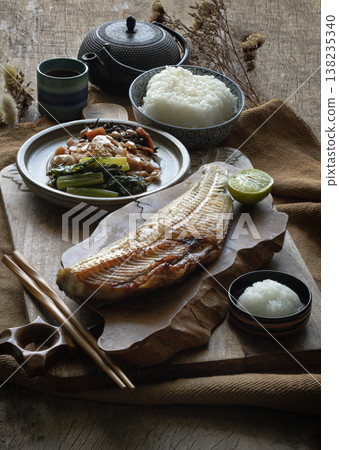 A masterpiece of Japanese tradition, this Teishoku set features a charcoal-grilled Shima Hokke, its skin crisped to a perfect golden-brown while the succulent Atka Mackerel remains tender within. The A masterpiece of Japanese tradition, this Teishoku set features a charcoal-grilled Shima Hokke, its skin crisped to a perfect golden-brown while the succulent Atka Mackerel remains tender within. The 138235340