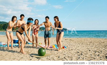 Friends enjoying watermelon smashing on the beach 138235378