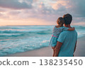Father holding daughter embracing a peaceful sunset view at the ocean beach, creating cherished family memories and bonding during a relaxing vacation travel 138235450