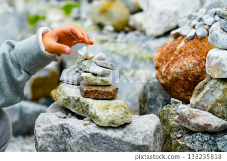 Relaxed spiritually child's hand arrangement pebble tower. Yoga relax meditation Relaxed spiritually child's hand arrangement pebble tower. Yoga relax meditation 138235818