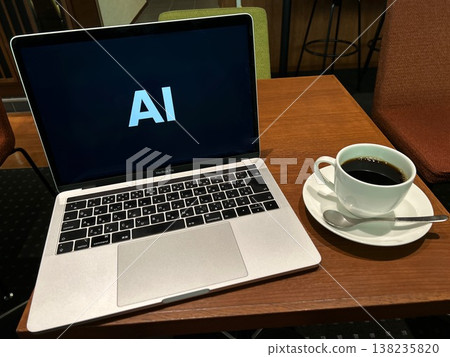 A laptop labeled "AI" and coffee 138235820