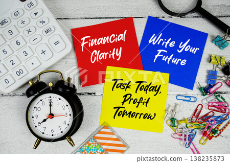Financial Clarity, Write Your Future, Task Today, Profit Tomorrow text written on paper note with calculator and magnifying glass on wooden background 138235873
