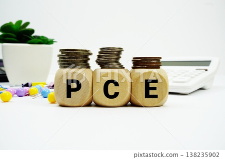 Stack of coins with wood blocks with "PCE (Personal Consumption Expenditures)" Financial concept 138235902