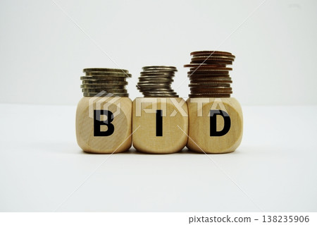 Stack of coins with wood blocks with "BID" Financial concept Stack of coins with wood blocks with "BID" Financial concept 138235906