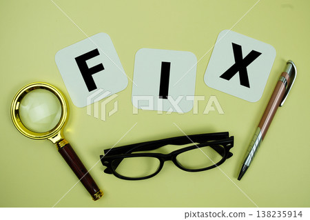 FIX alphabet letters with magnifying glass, eye glasses and pen on yellow background 138235914