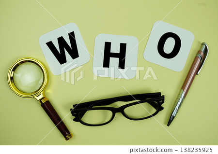 WHO alphabet letters with magnifying glass, eye glasses and pen on yellow background WHO alphabet letters with magnifying glass, eye glasses and pen on yellow background 138235925