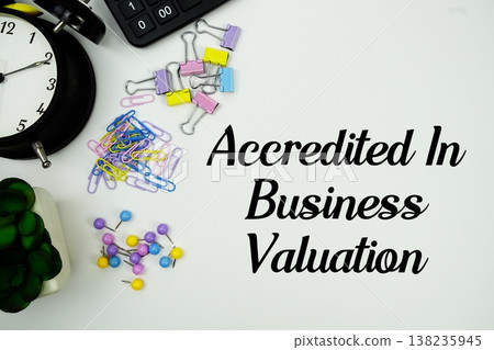 ABV Accredited in Business Valuation message with calculator, alarm clock and Stationery on white background 138235945