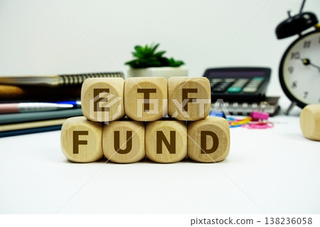 ETF Fund alphabet letters with calculator and alarm clock on white background ETF Fund alphabet letters with calculator and alarm clock on white background 138236058